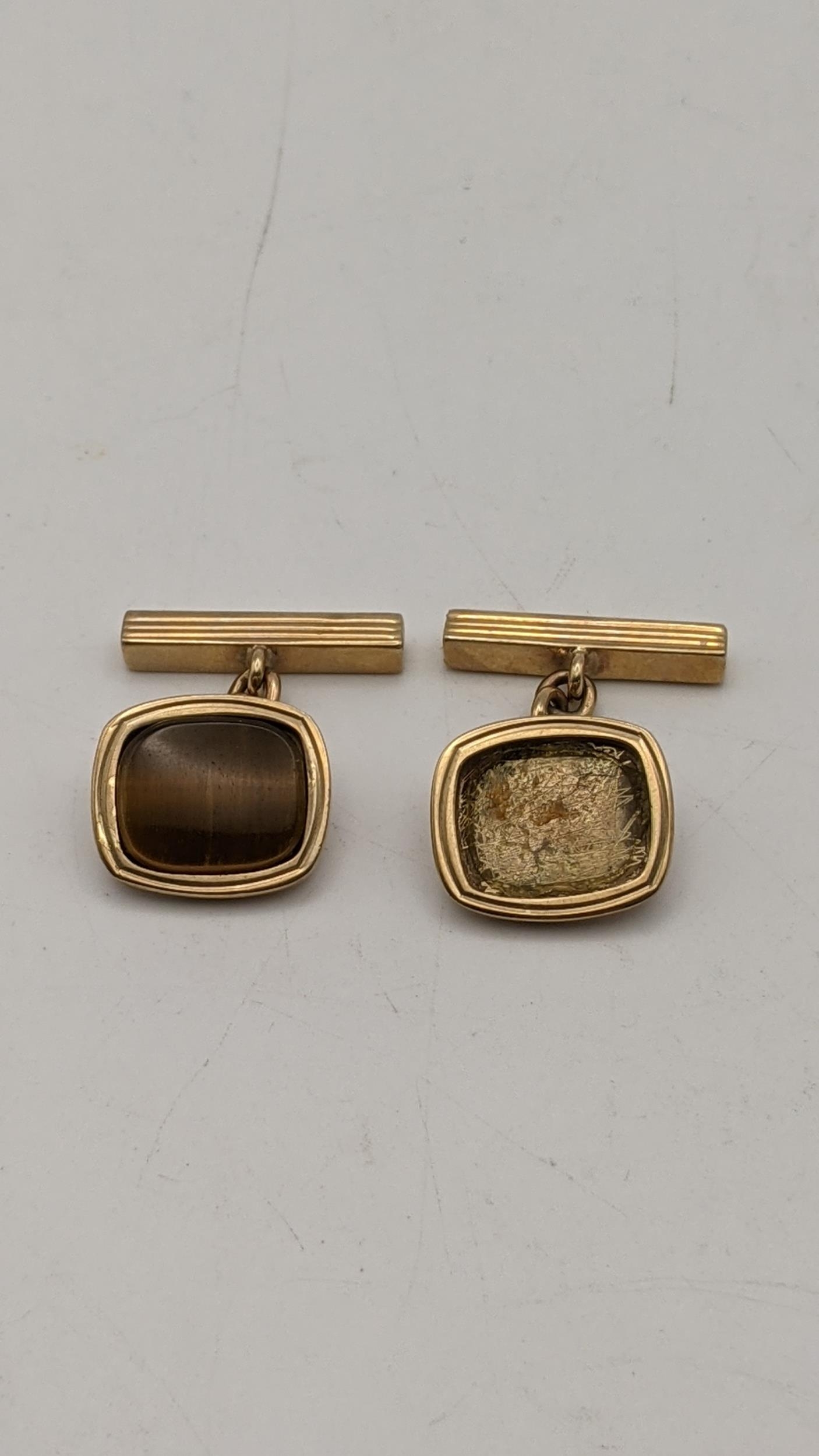 A pair of 9ct gold cufflinks, one with a missing stone, 7.45g Location: