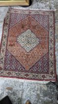 A Persian Bijar hand woven rug having a red ground, 160cm x 116cm Location: