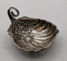 A sterling silver dish with embossed floral ornament and scrolled handle, stamped R 131g Location: