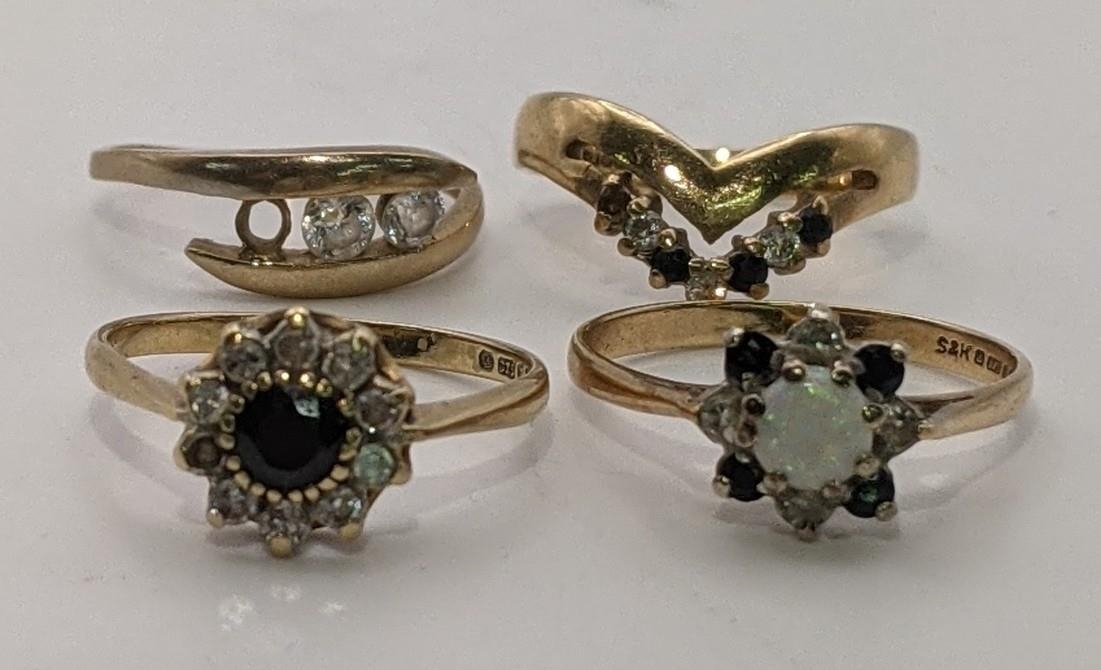 Three 9ct gold rings to include one set with a central opal, diamonds and sapphires, along with a