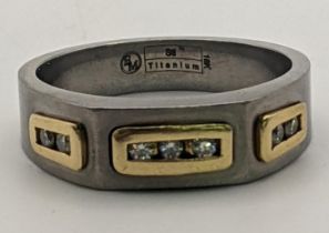 An 18ct gold and titanium gents ring set with seven diamonds 5.8g, size Y½ Location: