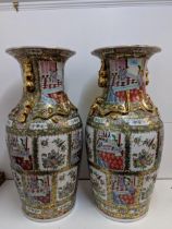 A pair of Chinese modern floor standing canton style vases decorated with panels of figures and