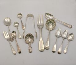 Mixed silver cutlery to include a fiddle pattern dinner fork, a pair of sugar tongs, a sugar sifter,