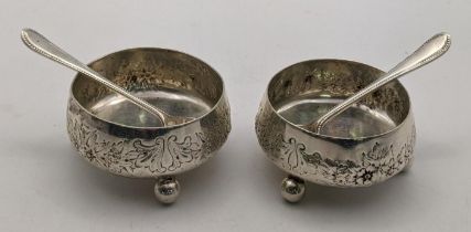 A pair of Mappin & Webb silver condiment pots and spoons having floral embossed decoration, total