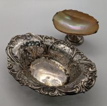 A silver pierced dish having floral edges, hallmarked Birmingham 1900, together with a faceted shell