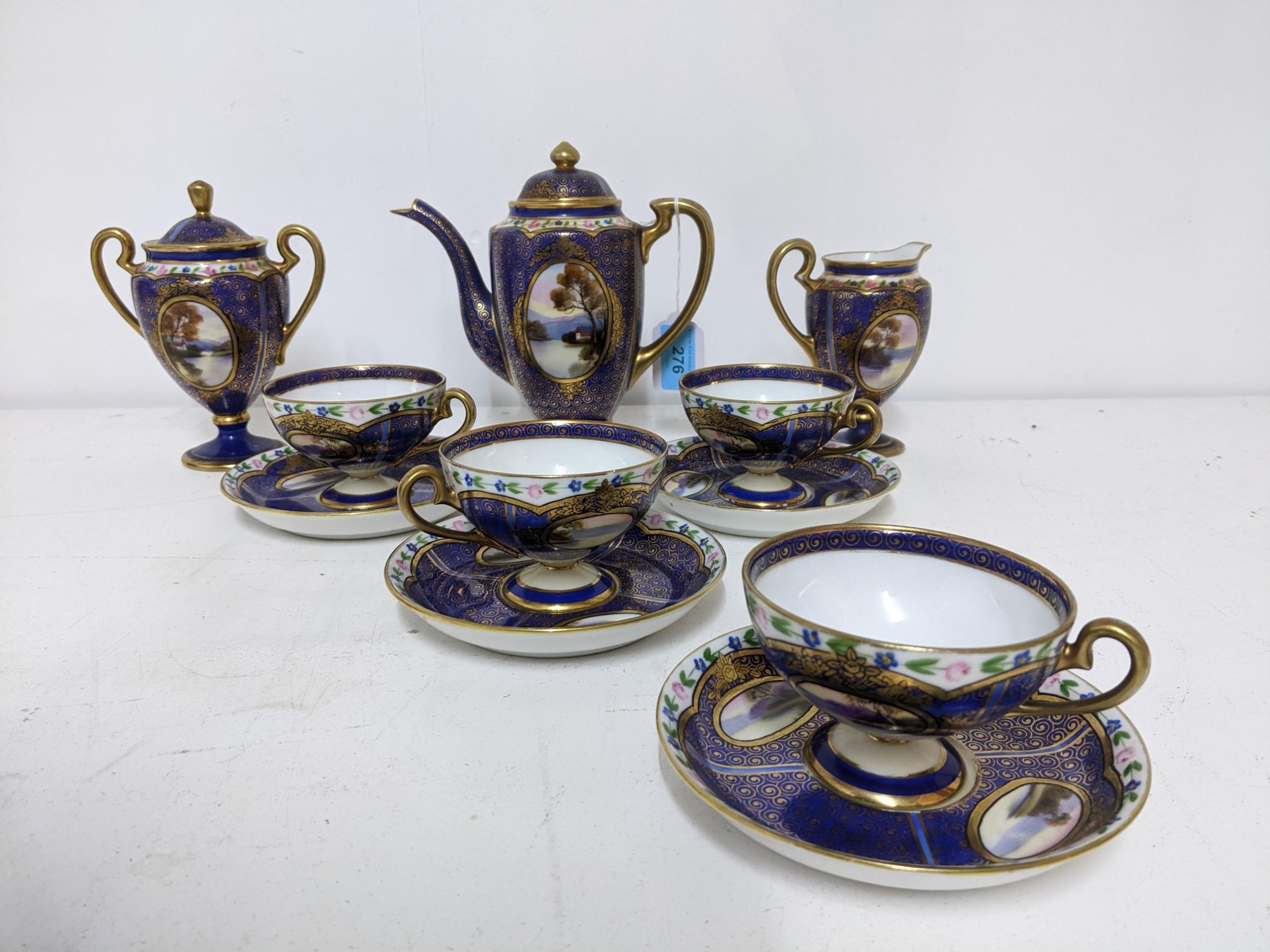 A Japanese Noritake porcelain four piece setting part coffee set, decorated with oval landscape