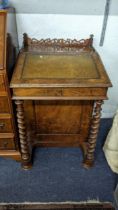 A Victorian walnut Davenport having pierced fretwork, green leather scriber and barley twist