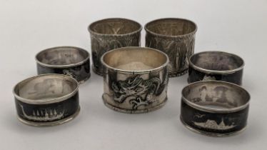 Mixed napkin rings to include a Chinese silver dragon napkin ring, four sterling silver Niello