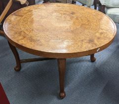 A burr elm circular topped table with another set of taller folding trestle legs, the top with a