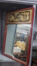 A mid 20th century Chinese red lacquered wall mirror having a pierced gilt scene above 72h x 46w