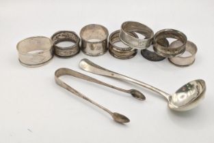 Mixed silver to include a silver sauce ladle, a variety of silver napkin rings, and a pair of