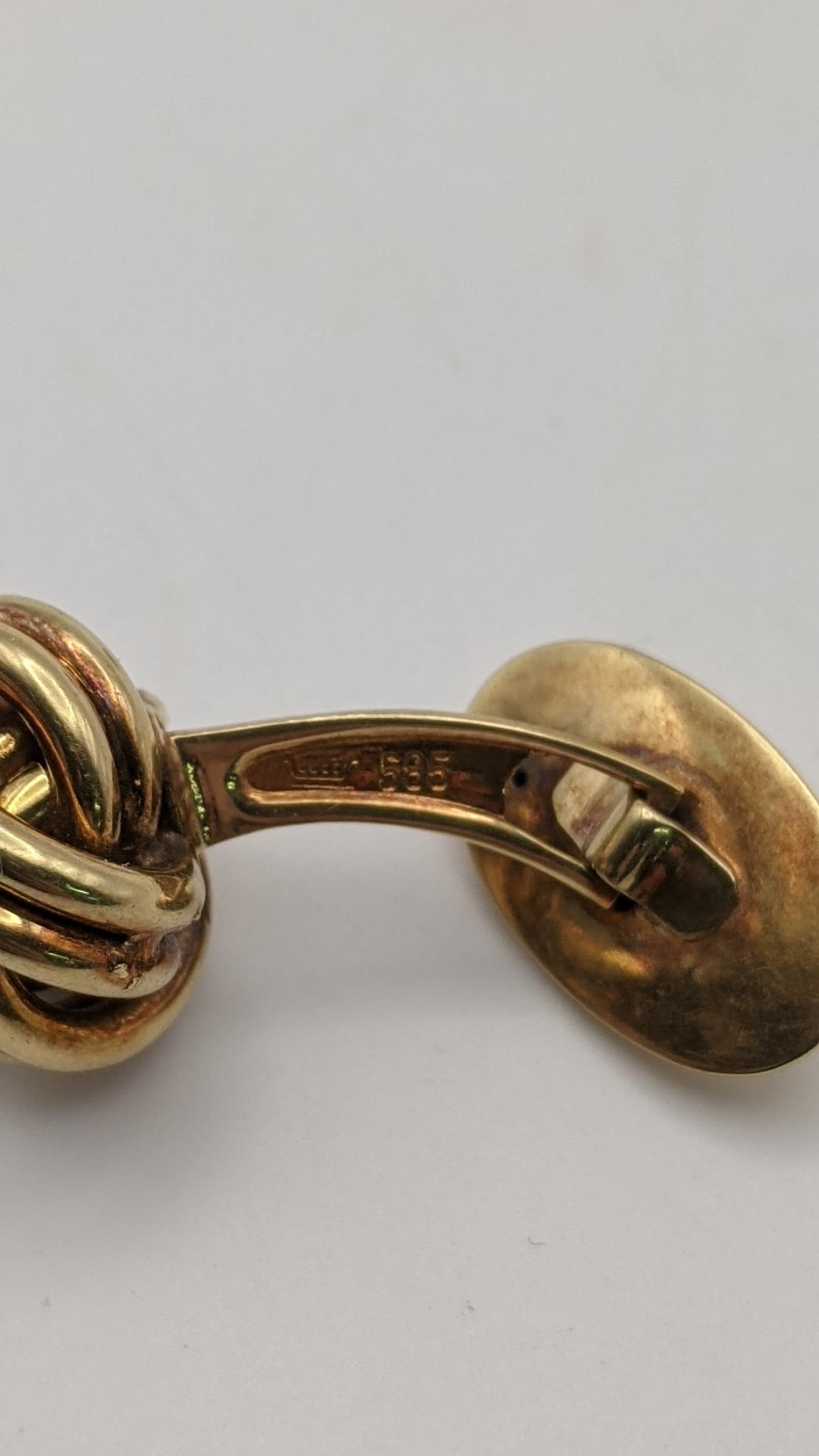 A pair of gold cufflinks of knot design, stamped 585, 10.3g Location: - Image 2 of 2