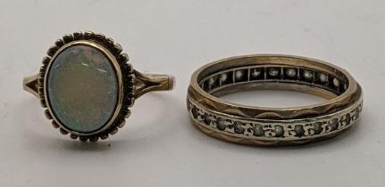 Two 9ct gold rings to include an opal ring together with a full eternity ring set with white