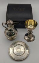 A Victorian gothic style silver communion set to include a chalice and ewer dated Sheffield 1868 and