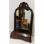 An 18th century walnut swing mirror with a fretworked cornice, square horn and a three drawer,