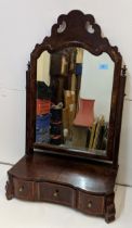 An 18th century walnut swing mirror with a fretworked cornice, square horn and a three drawer,