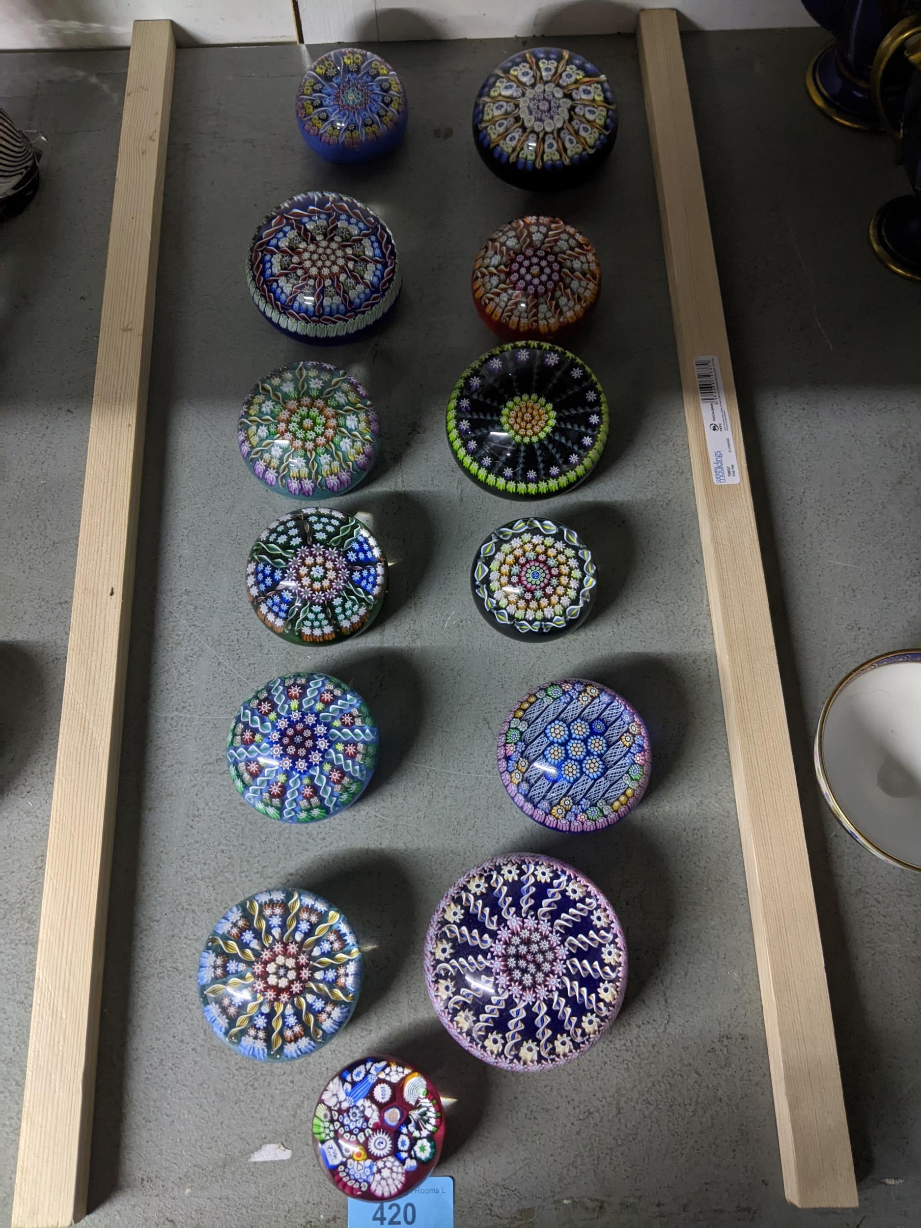 A group of Perthshire concentric millefiori and other paperweights of various sizes, along with a