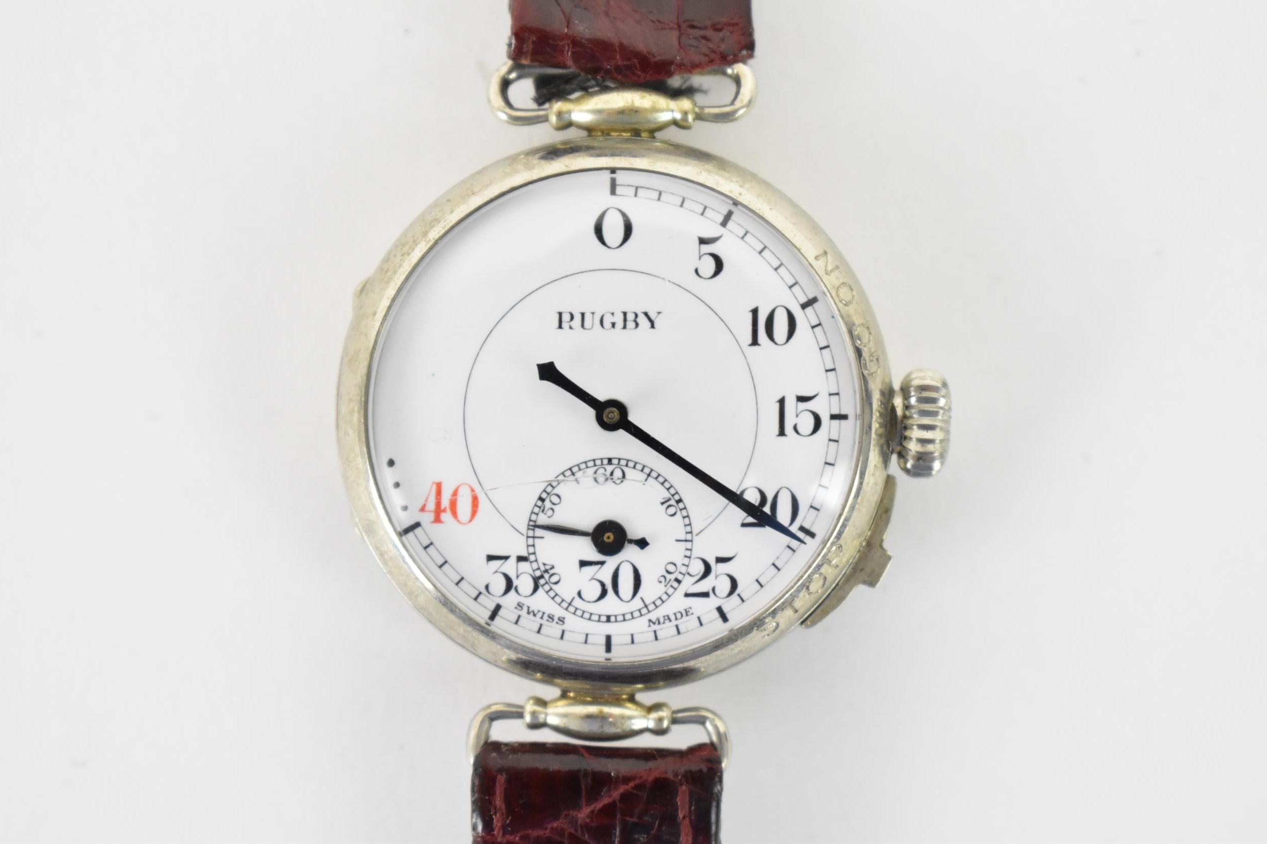 An unusual early 20th century trench style wristwatch to time a game of rugby, the white enamel dial