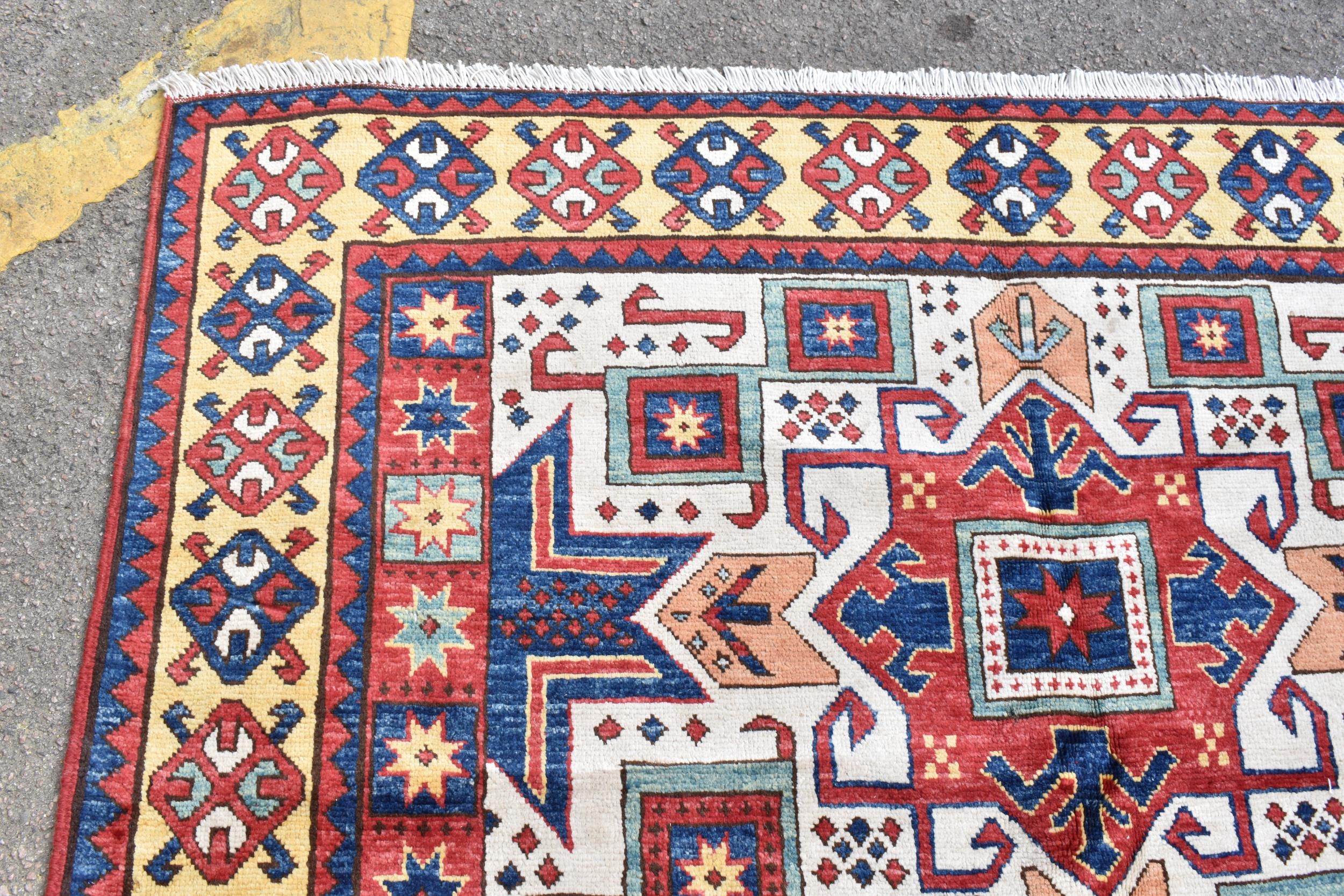 A handwoven Caucasian star kazak rug, having a geometric designs with repeating motifs, multiguard - Image 5 of 8