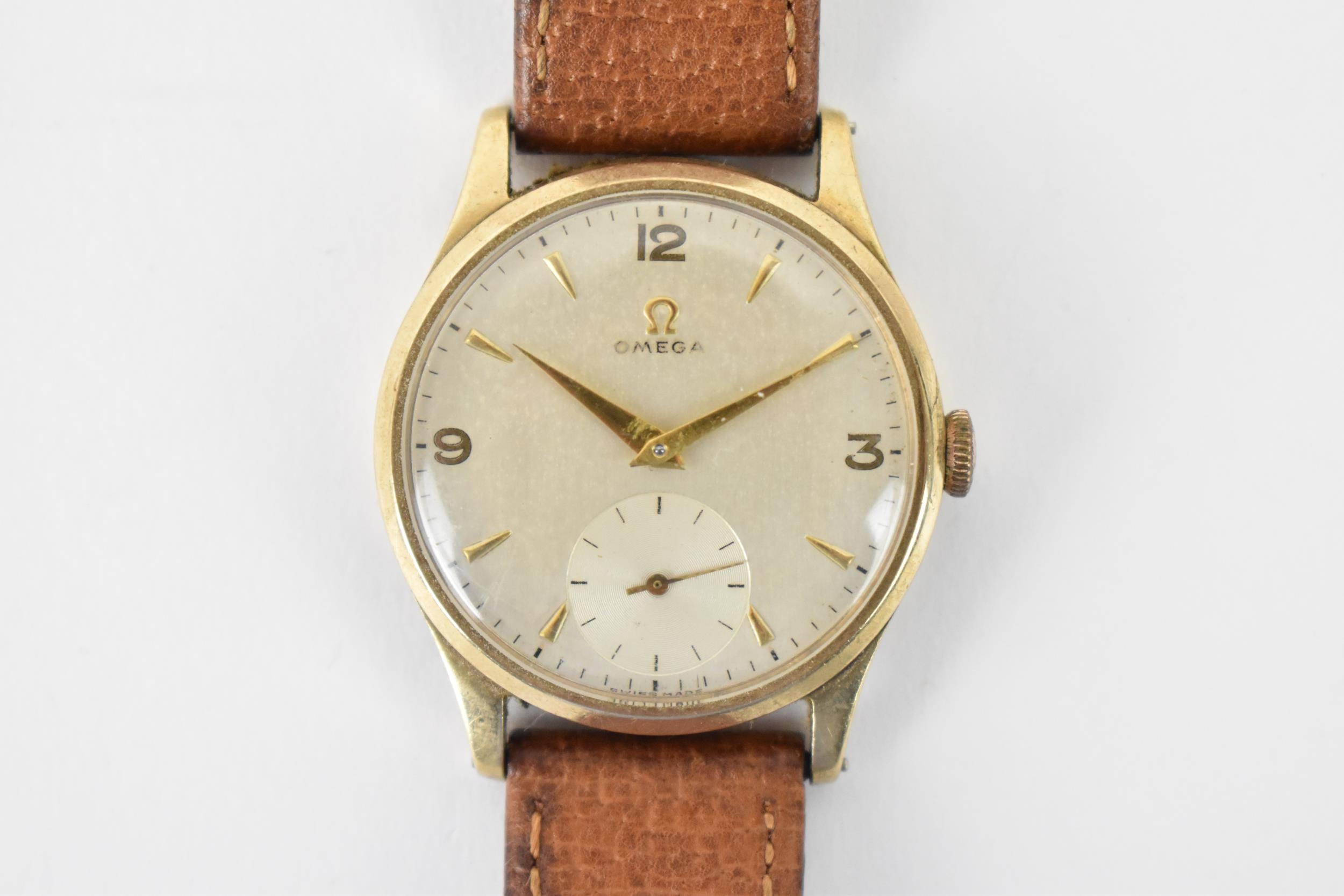 An Omega, manual wind, gents, 9ct gold wristwatch, circa 1950s, having a silvered dial, subsidiary