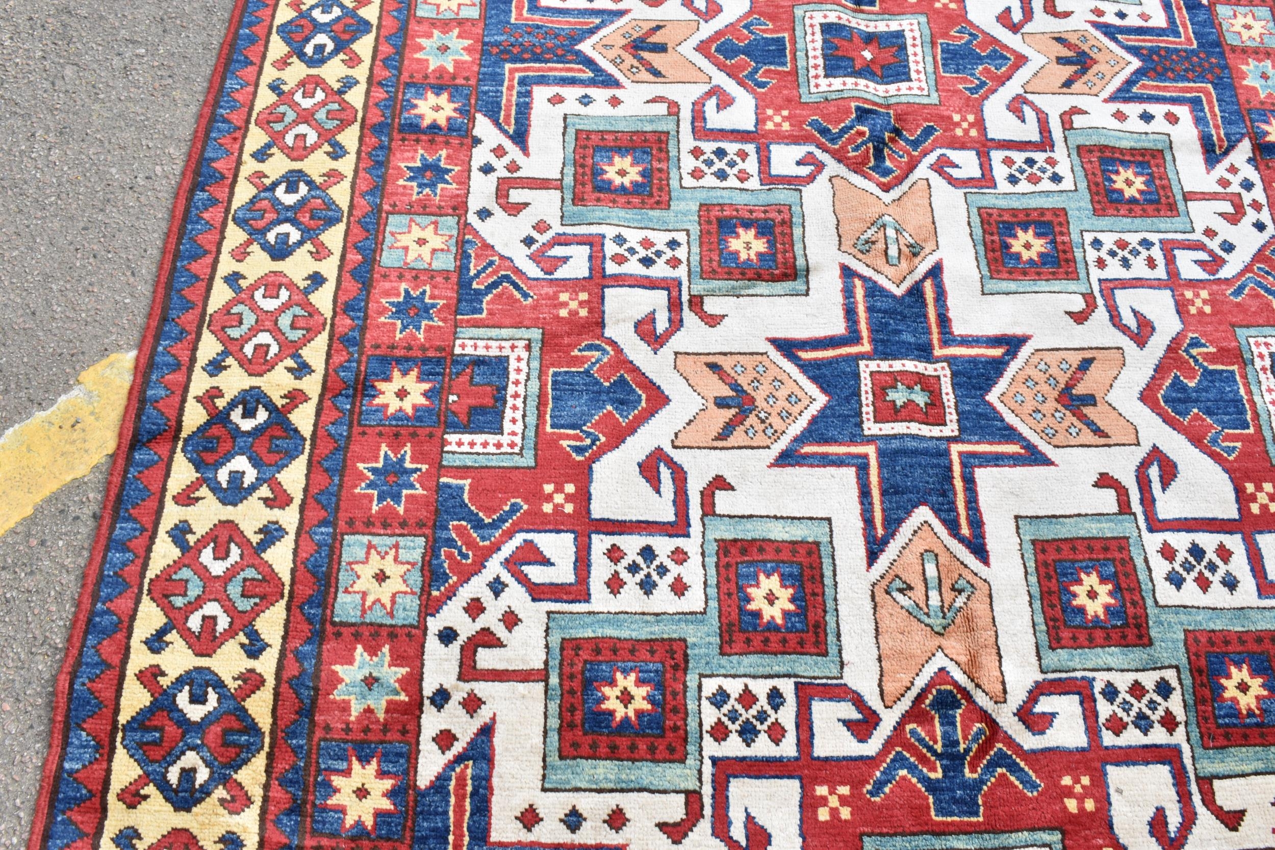 A handwoven Caucasian star kazak rug, having a geometric designs with repeating motifs, multiguard - Image 6 of 8