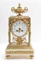 A late 19th century French mantle clock, having four bevelled glass panels applied with gilt metal