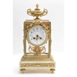 A late 19th century French mantle clock, having four bevelled glass panels applied with gilt metal