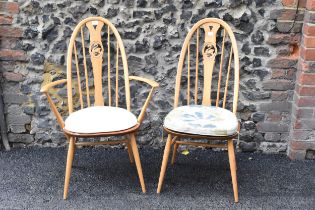 An Ercol vintage gold label, elm seated and beech framed swan back carver chair and matching