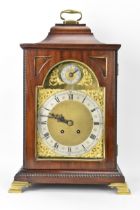 A late 19th/early 20th century mahogany 8 day mantle clock, the case having an inverted bell top