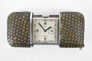 A Movado Chronometre Ermeto Art Deco steel and snake skin travelling purse watch, having a square