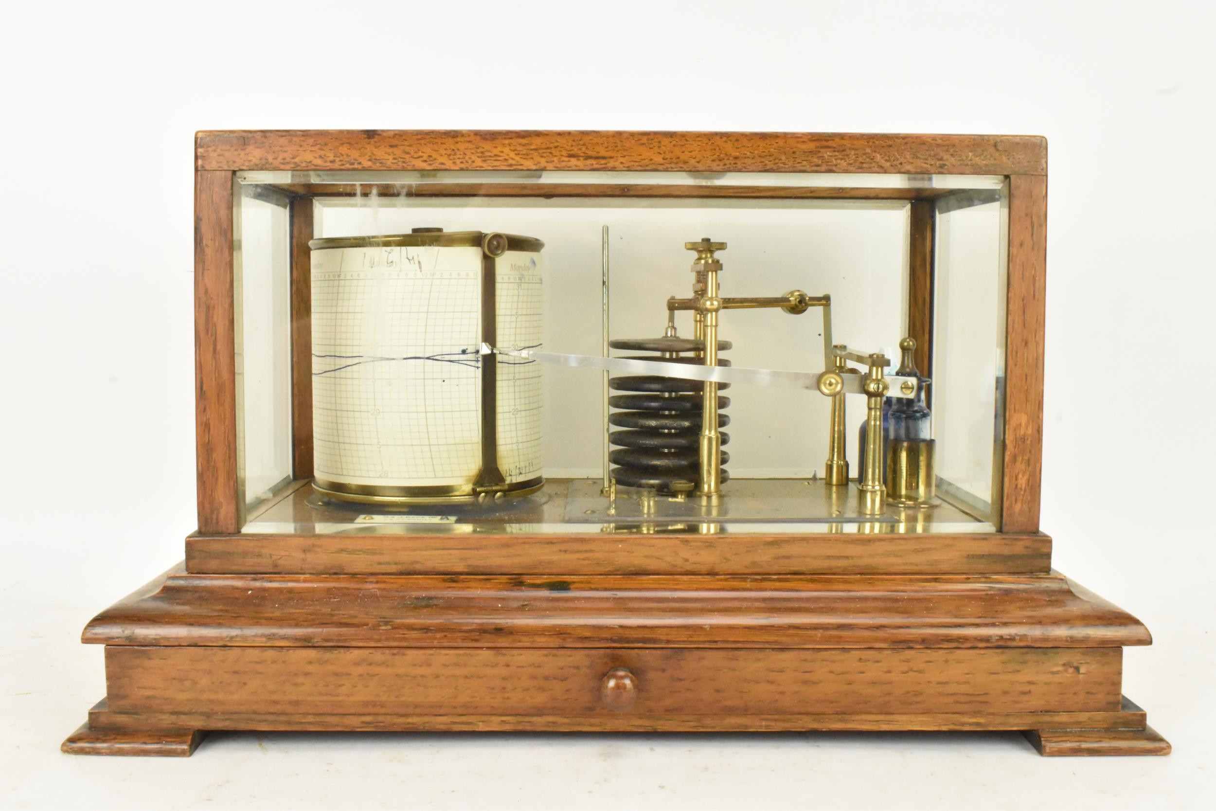 An early 20th century barograph, the oak case with bevelled glass and chart drawer, labelled 'J Beck