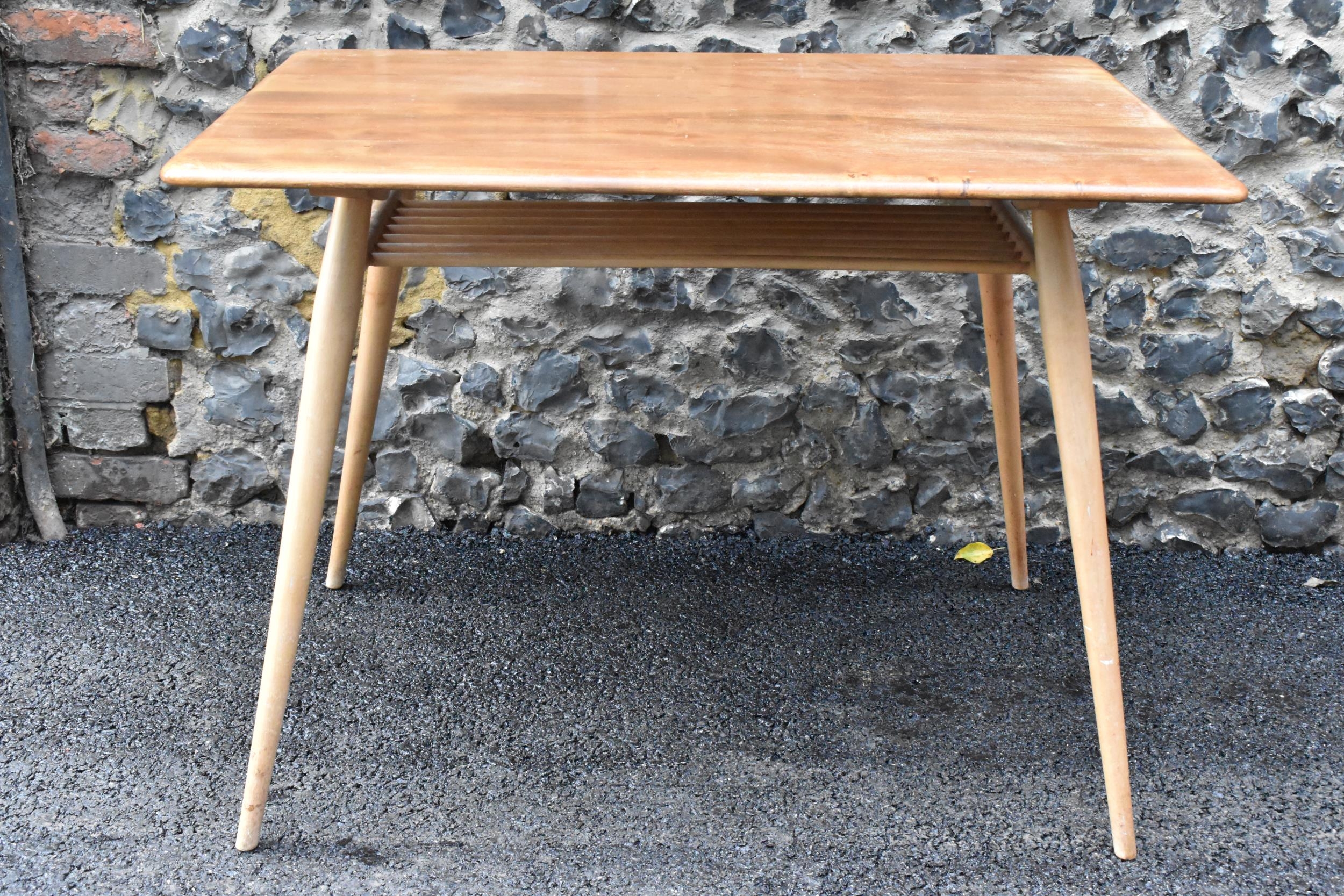 A 1960s Ercol blonde elm and beech breakfast table, model 395, having a rectangular top with a