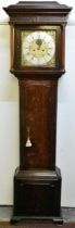 An 18th century oak longcase clock, the case having a stepped cornice with two turned pillars