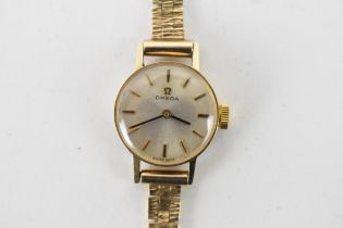 An Omega, manual wind, ladies, 9ct gold wristwatch, circa 1970s, having a silvered dial, baton