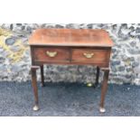 A George II mahogany lowboy, having a rectangular top with rounded corners, two drawers with brass