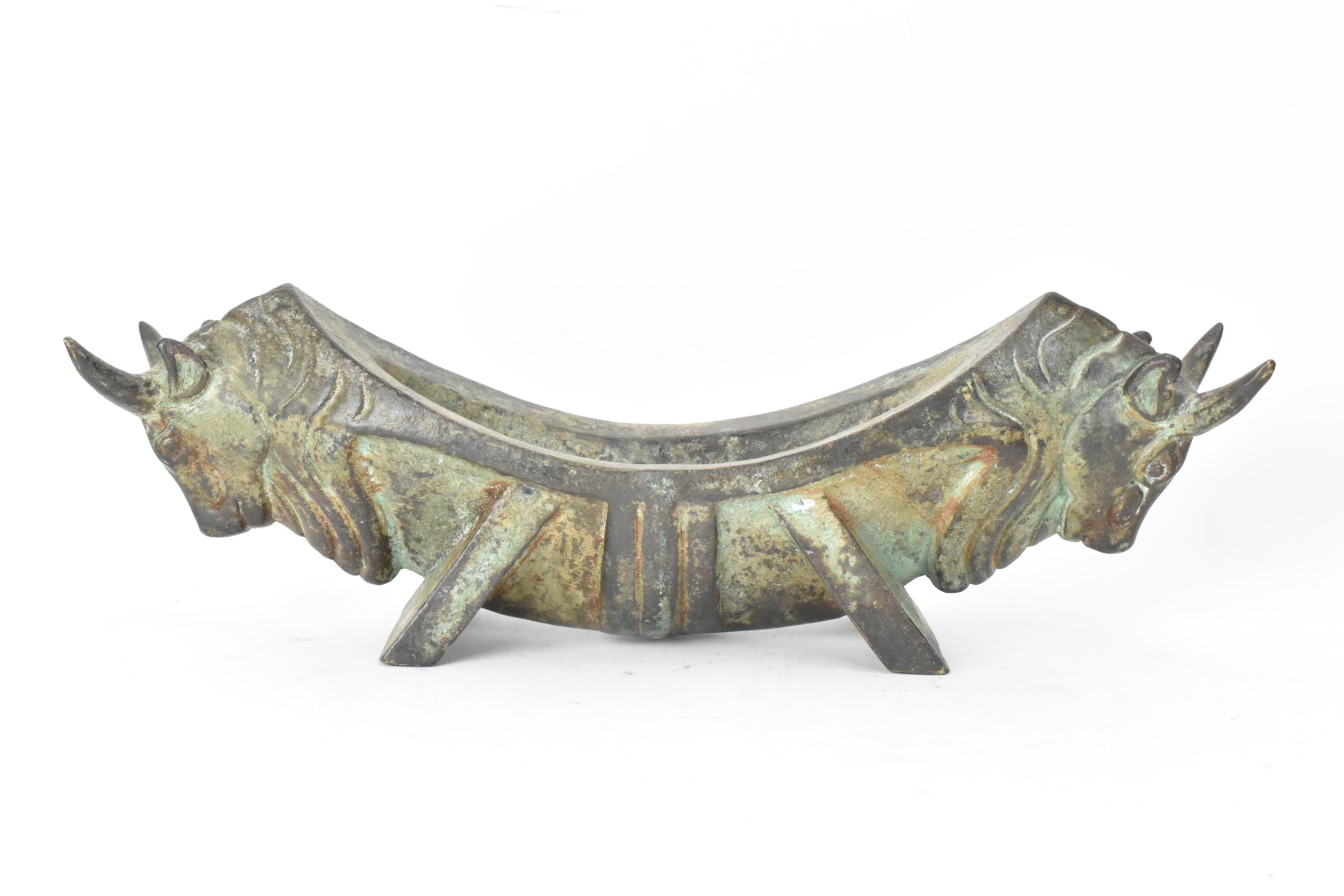 A 20th century Chinese patinated bronzed oblong shaped bowl, the sides fashioned as two bulls