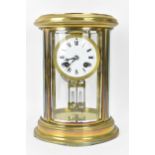 A late 19th/early 20th century French mantle clock, having a lacquered brass case with curved