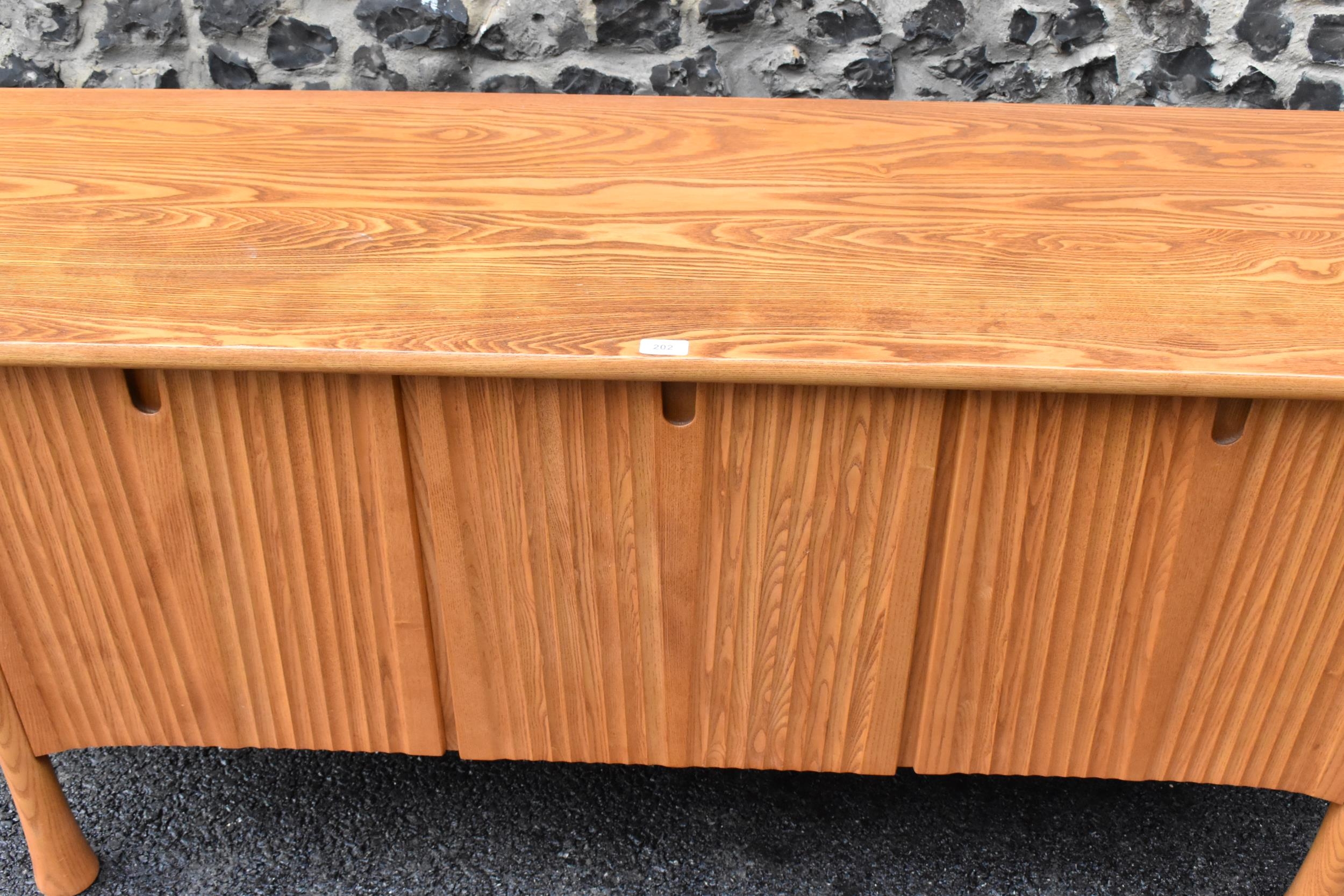 A rare 20th century Ercol Saville elm sideboard The oversized plank top raised over a ridged base - Image 3 of 6
