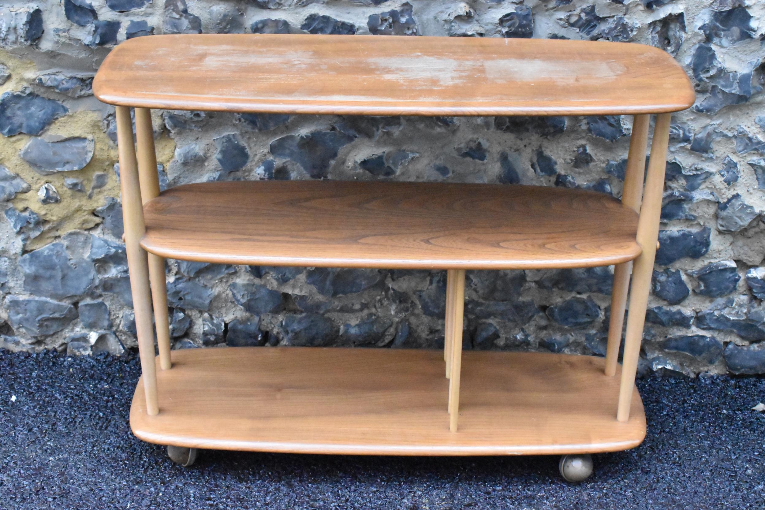 A mid 20th century Ercol elm and beech Baby Giraffe three tier trolley, model 361, Windsor range,