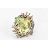 A silver dress ring inset with a large lemon quartz to the centre, decorated with a dolphin and