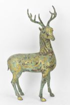 A Chinese patinated bronzed model of a stag, decorated with gilt scroll designs and character marks,