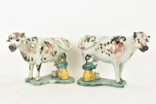 Two early 19th century pearlware pink and green sponge decorated cow creamers with milkmaids,