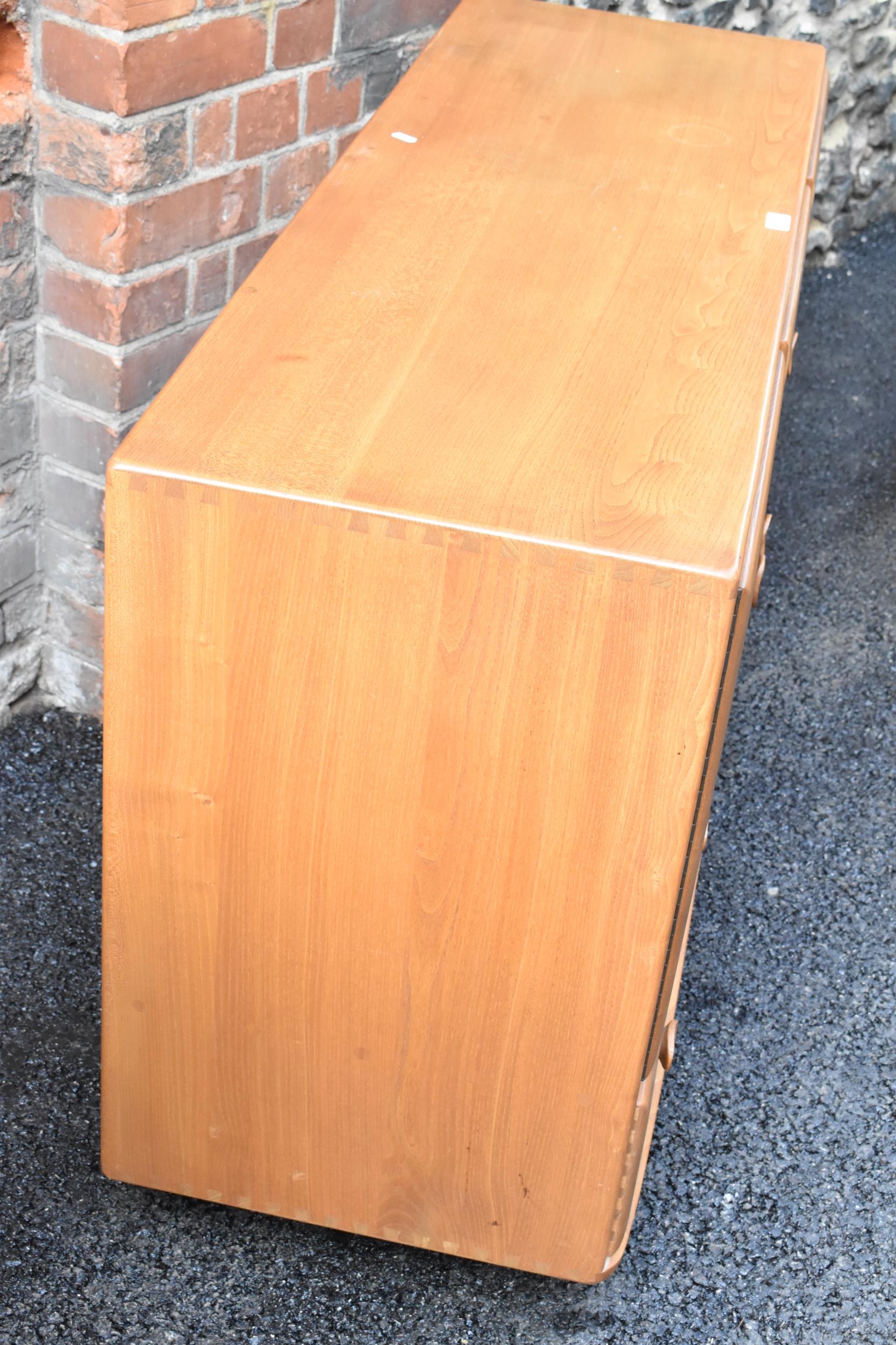 A mid 20th century Ercol Windsor range light elm sideboard, mode 468, having three cupboard doors - Image 4 of 6