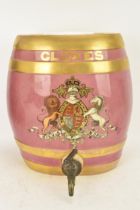 A Victorian ceramic cloves barrel, of oval shape and decorated with a pink ground with gilt bands