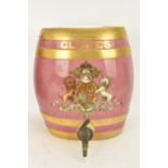 A Victorian ceramic cloves barrel, of oval shape and decorated with a pink ground with gilt bands