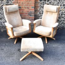 A pair of vintage Ercol Gina light elm manual reclining armchairs upholstered in beige fabric with