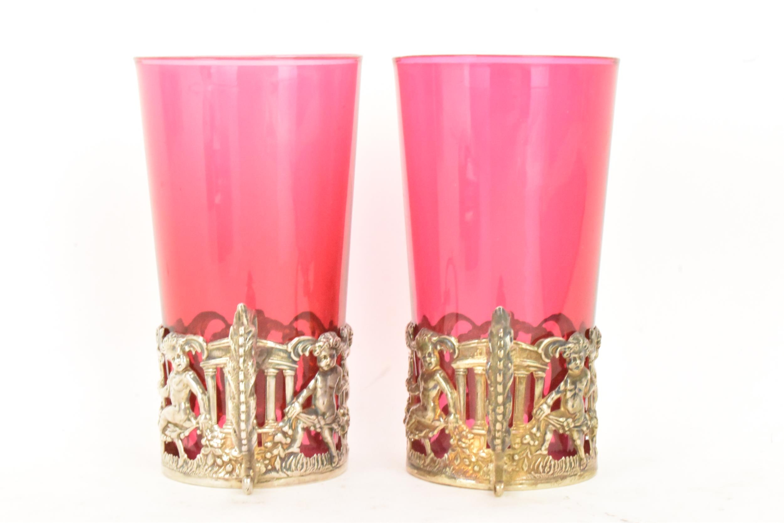 A pair of Edwardian silver glass holders with a pair of cranberry glasses, the holders ornately - Image 2 of 6