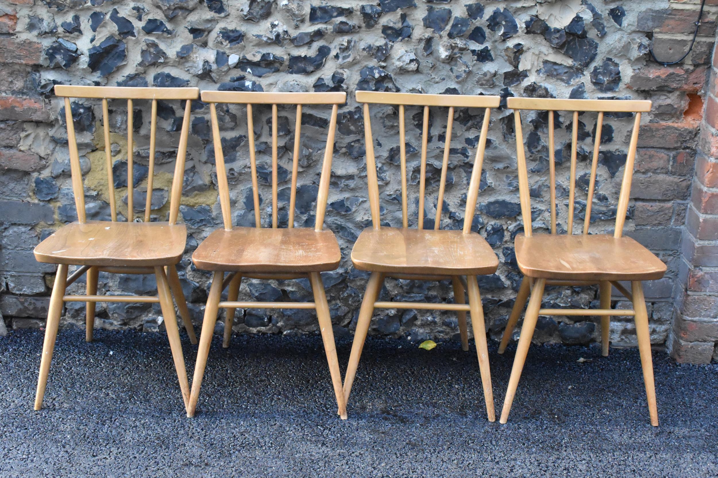 A set of four Ercol blonde elm and beech kitchen dining chairs, model 391, having spindle stick back