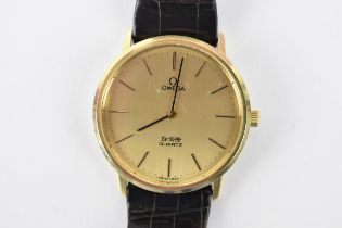 An Omega, quartz, gents, 18ct gold wristwatch, having a gilt dial, baton markers, on a Omega leather
