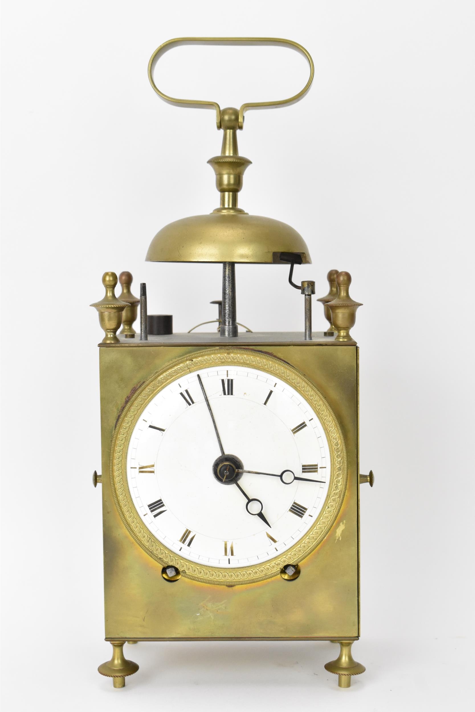 An early 19th century French capucine travel alarm clock, having a 3.5 inch white enamel dial with